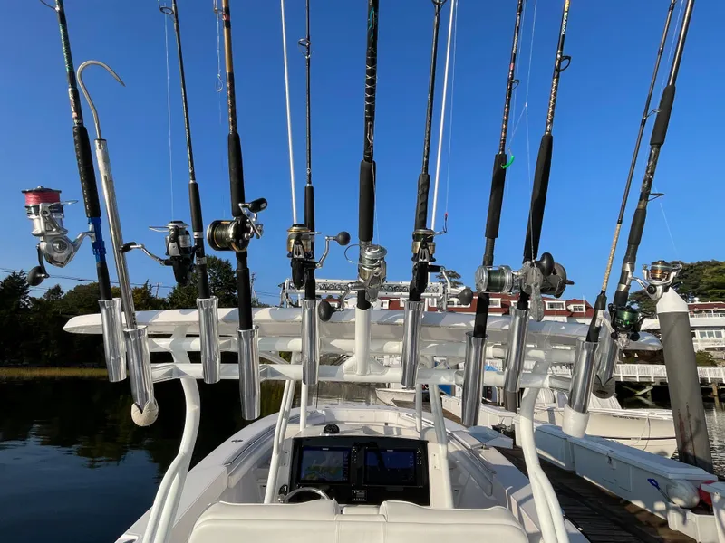 Slide: The Image of Fishing rods on a 2018 Southport 33 FE boat docked at a marina. - 19
