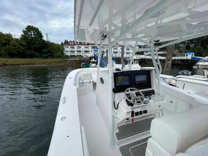 Slide: The Image of 2018 Southport 33 FE boat docked near waterfront buildings. - 21