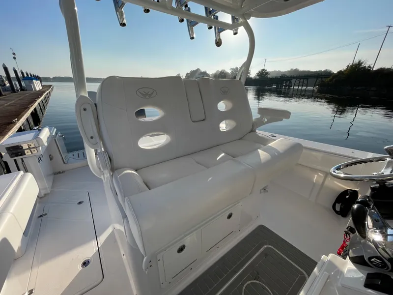 Slide: The Image of 2018 Southport 33 FE boat interior with white seating and calm waters in the background. - 24