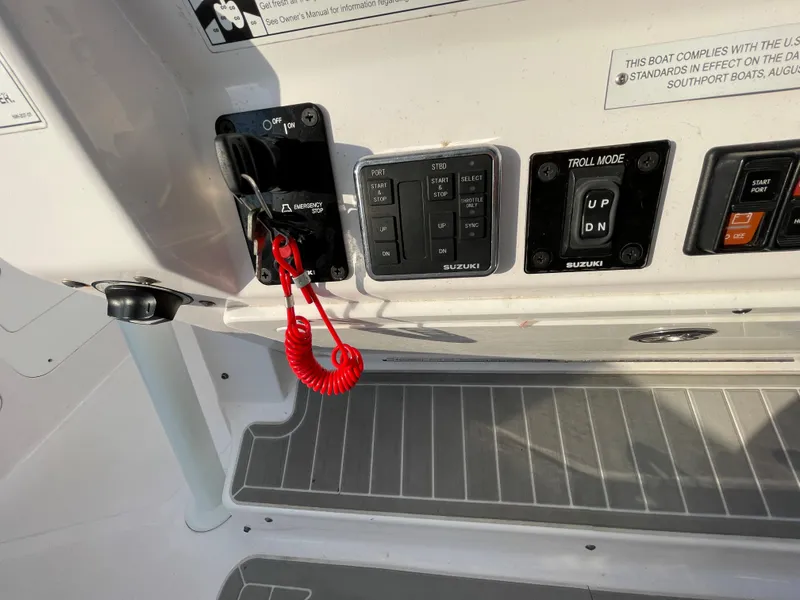 Slide: The Image of Control panel of a 2018 Southport 33 FE boat with switches and safety lanyard. - 30