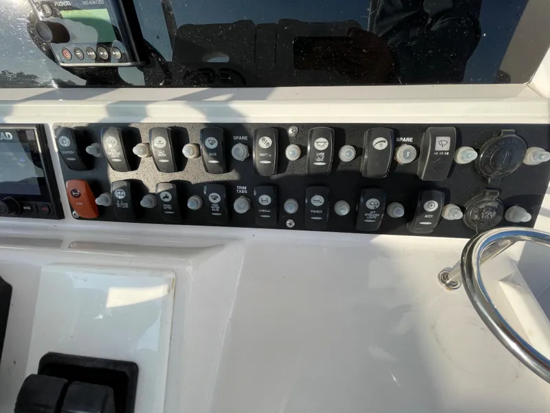 Slide: The Image of Control panel of a 2018 Southport 33 FE boat with various switches and buttons. - 31