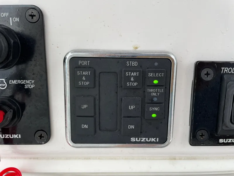 Slide: The Image of Control panel of a 2018 Southport 33 FE boat with Suzuki engine controls. - 34