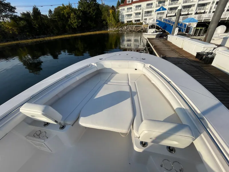 Slide: The Image of 2018 Southport 33 FE boat with white seating at a marina. - 38