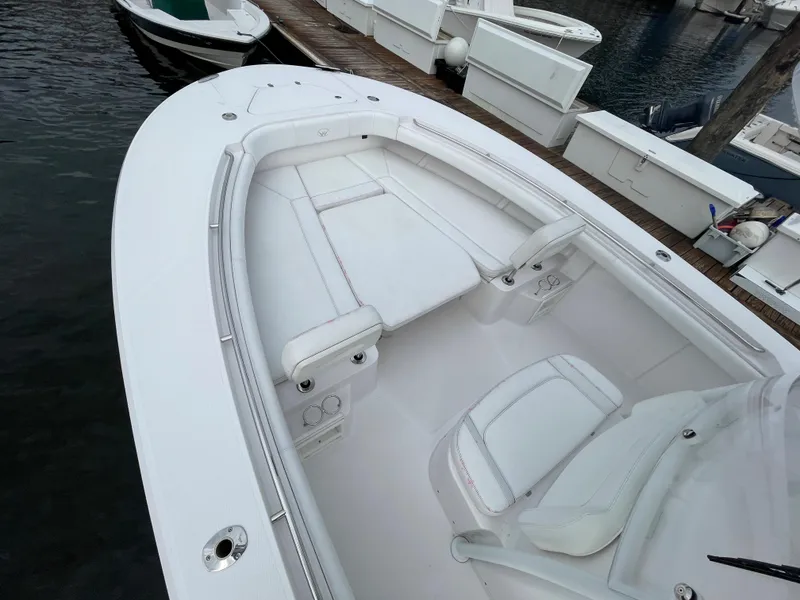 Slide: The Image of 2018 Southport 33 FE boat interior with white seating and docked at marina. - 39