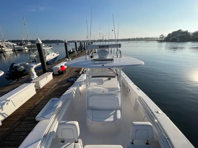 Slide: The Image of 2018 Southport 33 FE boat docked at a marina, calm water, and clear sky. - 44