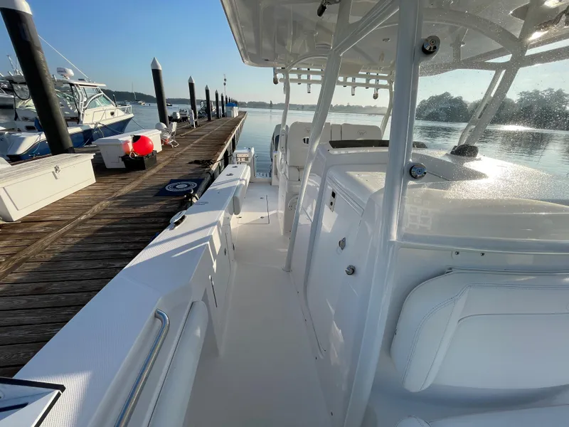 Slide: The Image of 2018 Southport 33 FE boat docked at a marina on a sunny day. - 49