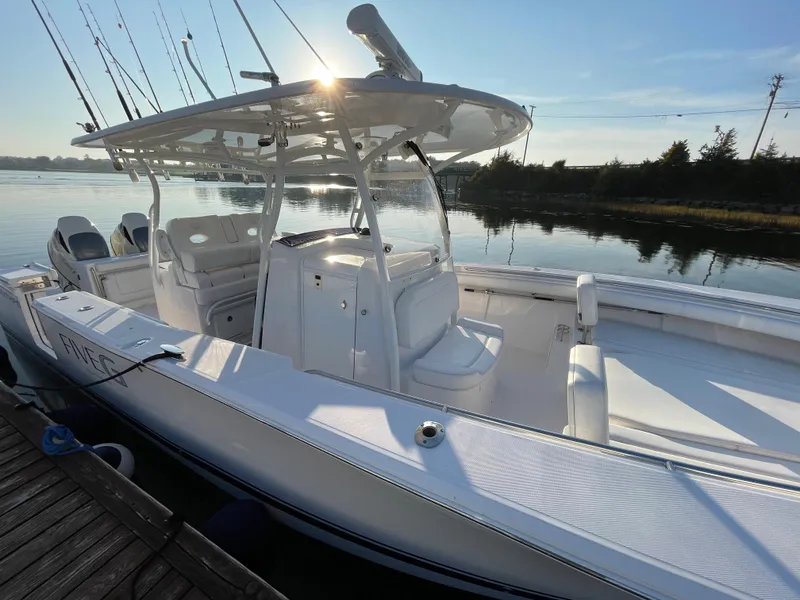Slide: The Image of 2018 Southport 33 FE boat docked by a serene waterfront. - 5