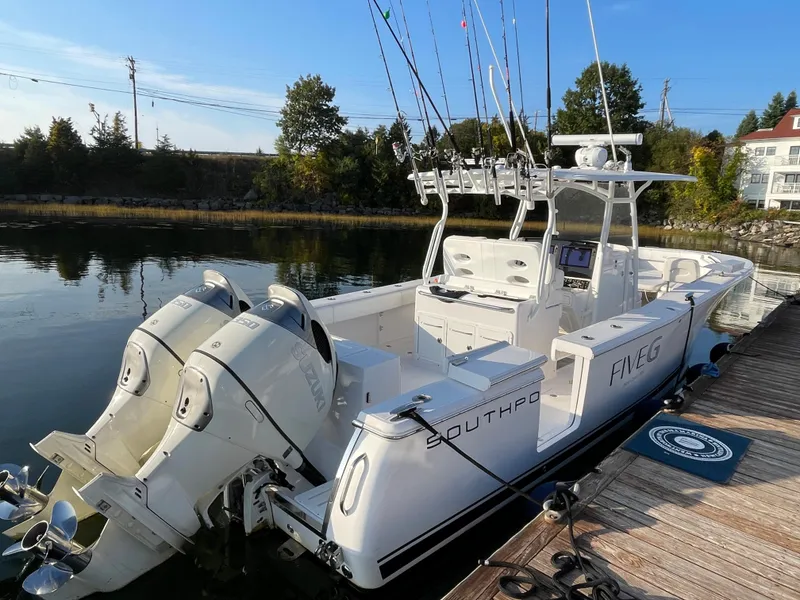 Slide: The Image of 2018 Southport 33 FE boat docked with twin outboard engines. - 7