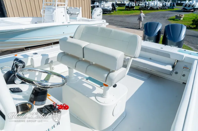 Slide: The Image of 2020 Parker 2801cc boat interior with dual engines and steering console. - 10