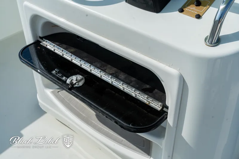 Slide: The Image of 2020 Parker 2801cc boat compartment with open hatch and visible interior details. - 19