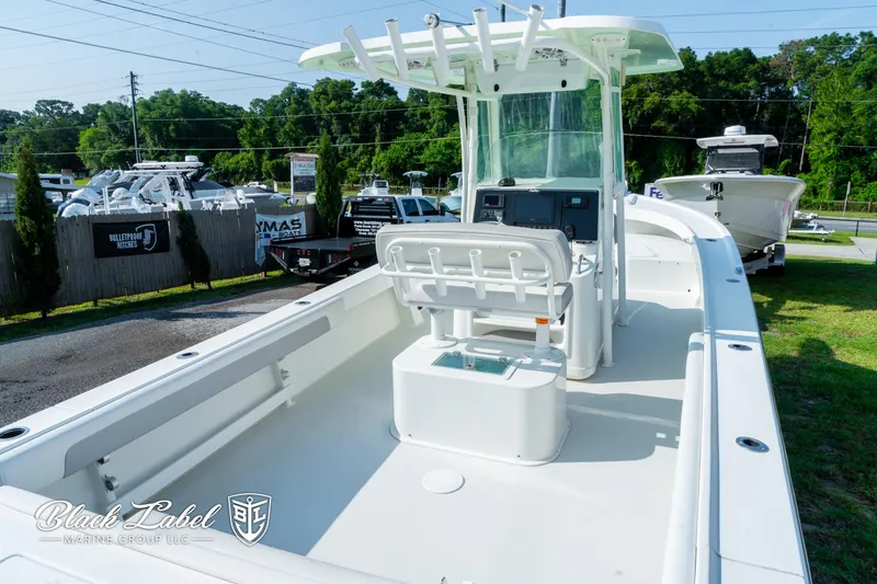 Slide: The Image of 2020 Parker 2801cc boat with center console, displayed outdoors in a marina setting. - 24