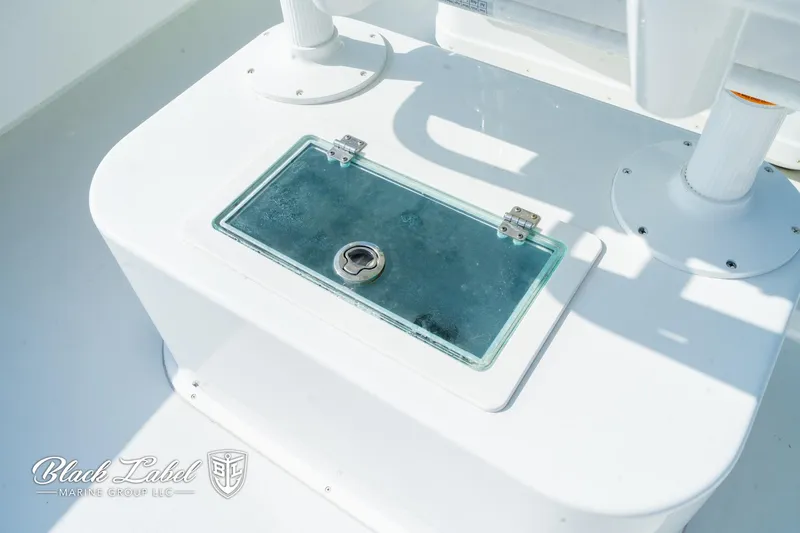 Slide: The Image of 2020 Parker 2801cc boat storage compartment with glass lid and lock. - 25