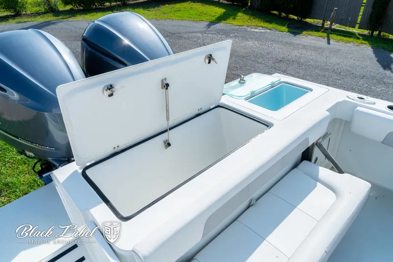 Slide: The Image of 2020 Parker 2801cc boat with open storage compartment and twin engines. - 28