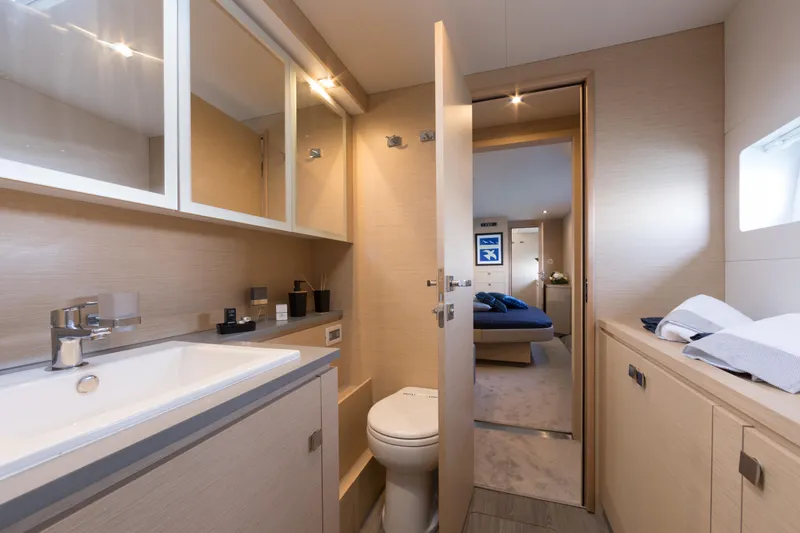 Slide: The Image of Modern bathroom on the 2025 Fountaine Pajot MY 6 yacht with sink, toilet, and storage. - 12