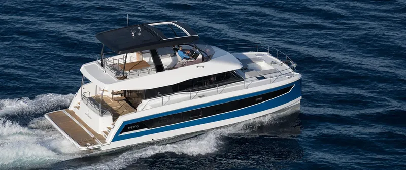 Slide: The Image of 2025 Fountaine Pajot MY 6 luxury motor yacht cruising on open water. - 1
