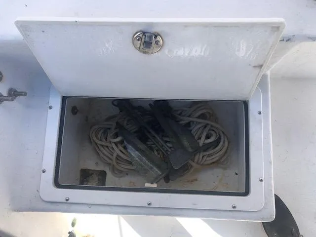 Slide: The Image of Open storage compartment on a 2021 May-Craft 1800 Skiff with ropes and anchors. - 13