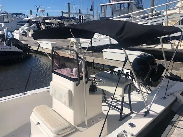 Slide: The Image of 2021 May-Craft 1800 Skiff boat docked at a marina with a black canopy. - 16