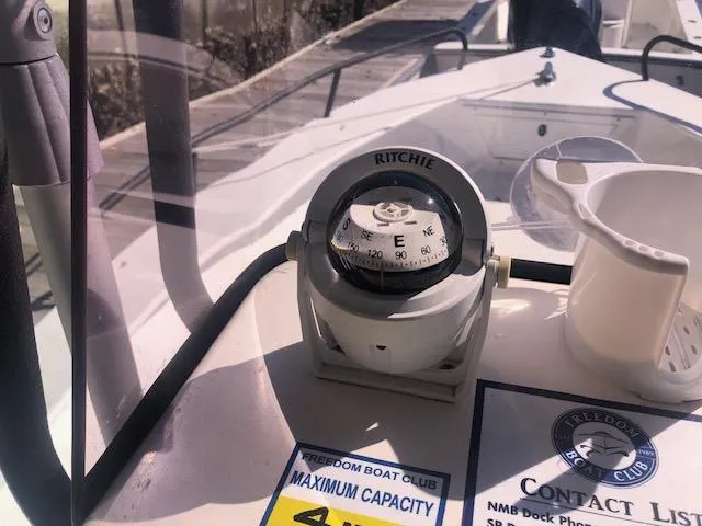 Slide: The Image of Ritchie compass on the dashboard of a 2021 May-Craft 1800 Skiff boat. - 9