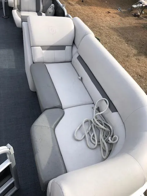 Slide: The Image of 2021 Sweetwater 2286 boat interior with white and gray seating. - 7