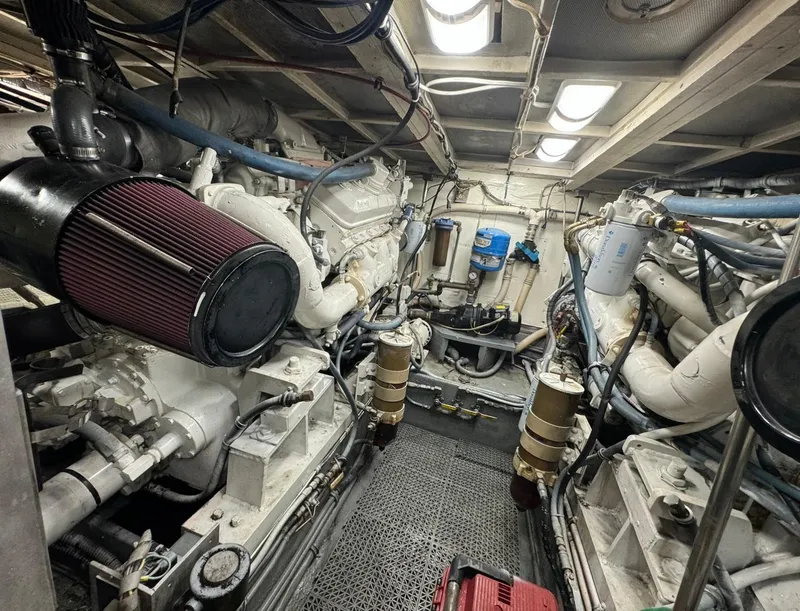 Slide: The Image of Engine room of a 1990 Hatteras 45 Convertible yacht, showcasing mechanical components and systems. - 10
