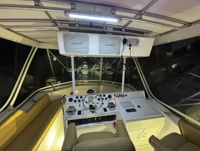 Slide: The Image of Interior cockpit of 1990 Hatteras 45 Convertible boat with Garmin navigation systems. - 13
