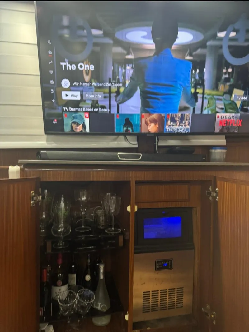 Slide: The Image of Entertainment setup on a 1990 Hatteras 45 Convertible yacht with TV and bar cabinet. - 16