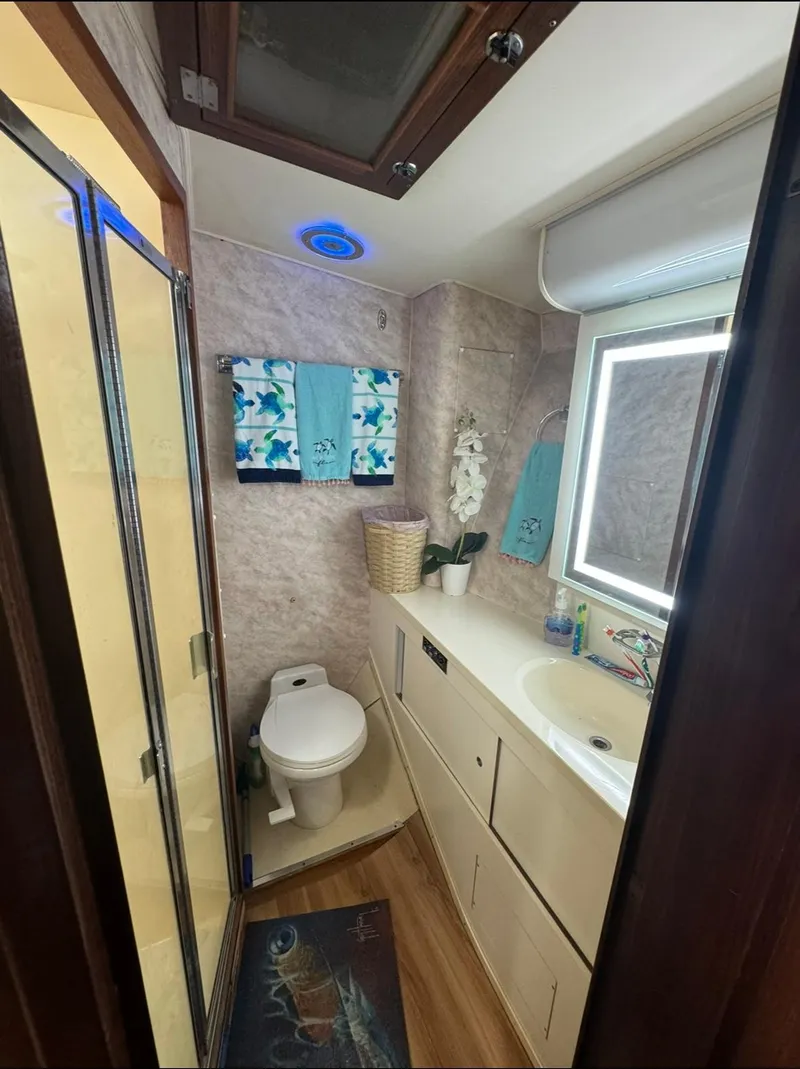 Slide: The Image of Bathroom interior of 1990 Hatteras 45 Convertible yacht, featuring modern amenities and nautical decor. - 22