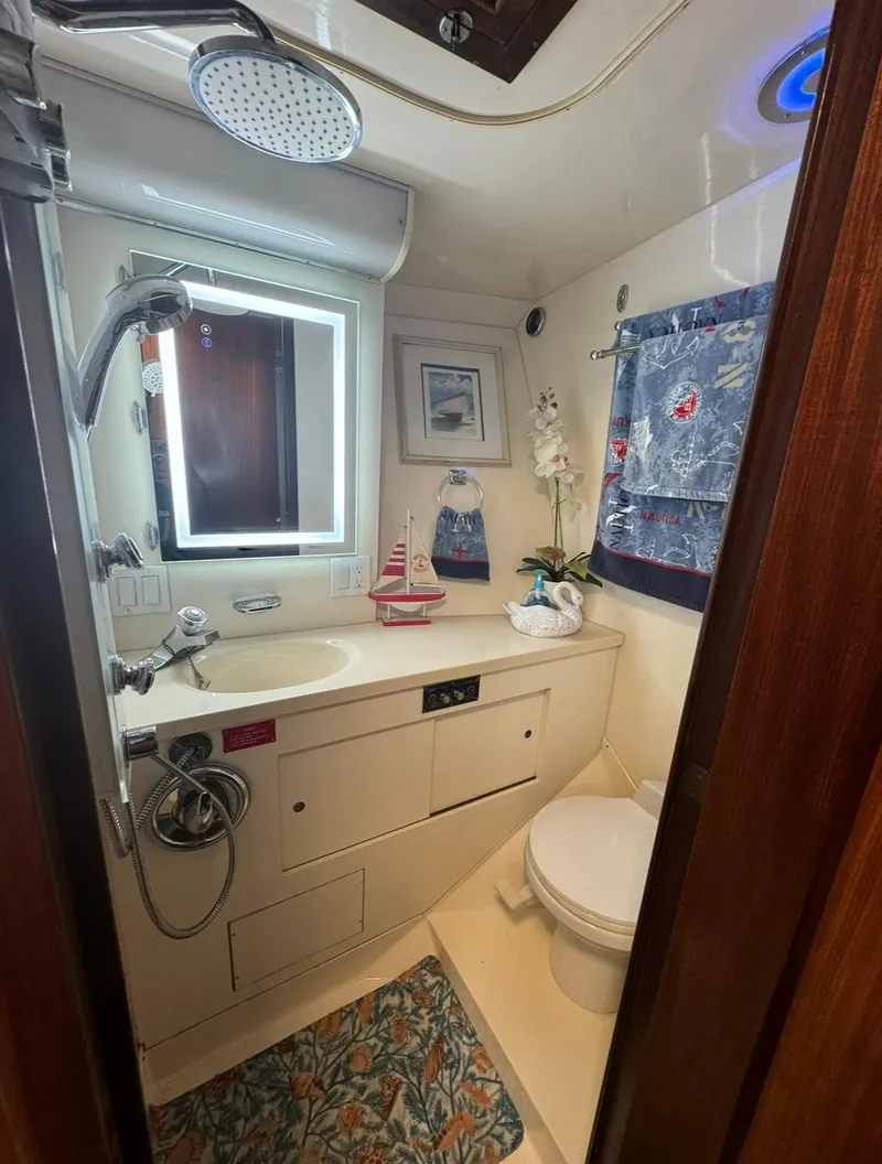 Slide: The Image of Bathroom interior of 1990 Hatteras 45 Convertible yacht, featuring nautical decor and modern amenities. - 23