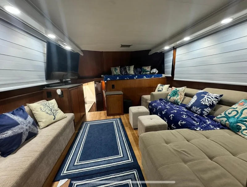 Slide: The Image of Interior of 1990 Hatteras 45 Convertible yacht with cozy seating and nautical decor. - 25