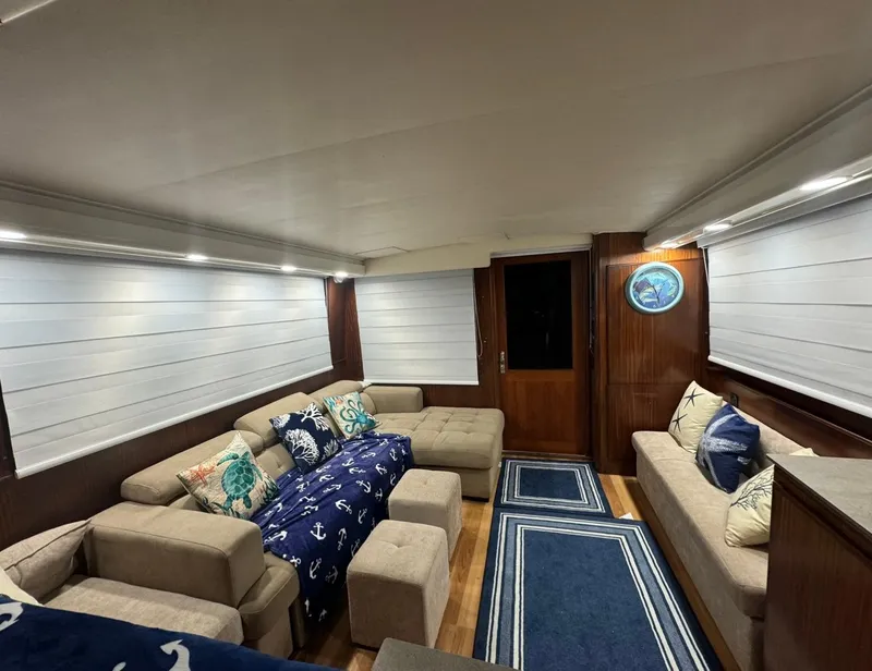 Slide: The Image of Luxurious interior of 1990 Hatteras 45 Convertible yacht with cozy seating and nautical decor. - 26