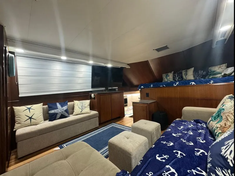 Slide: The Image of Interior of 1990 Hatteras 45 Convertible yacht with cozy seating and nautical decor. - 27