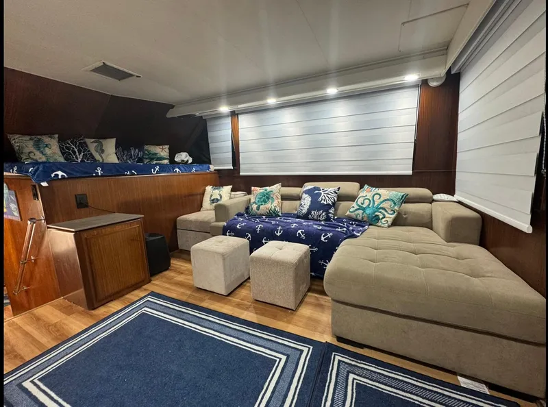 Slide: The Image of Luxurious interior of 1990 Hatteras 45 Convertible yacht with cozy seating and nautical decor. - 28