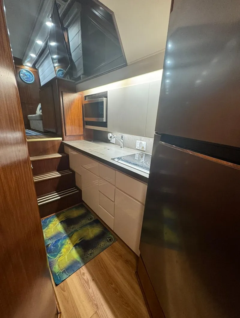 Slide: The Image of Modern kitchen interior of 1990 Hatteras 45 Convertible yacht with sleek cabinetry and appliances. - 29