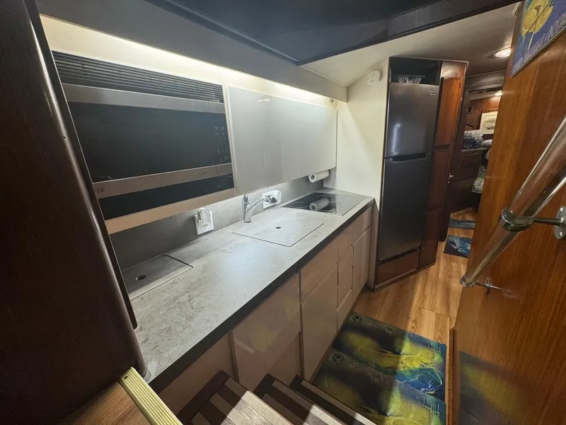 Slide: The Image of Kitchen area of a 1990 Hatteras 45 Convertible yacht with modern appliances. - 30