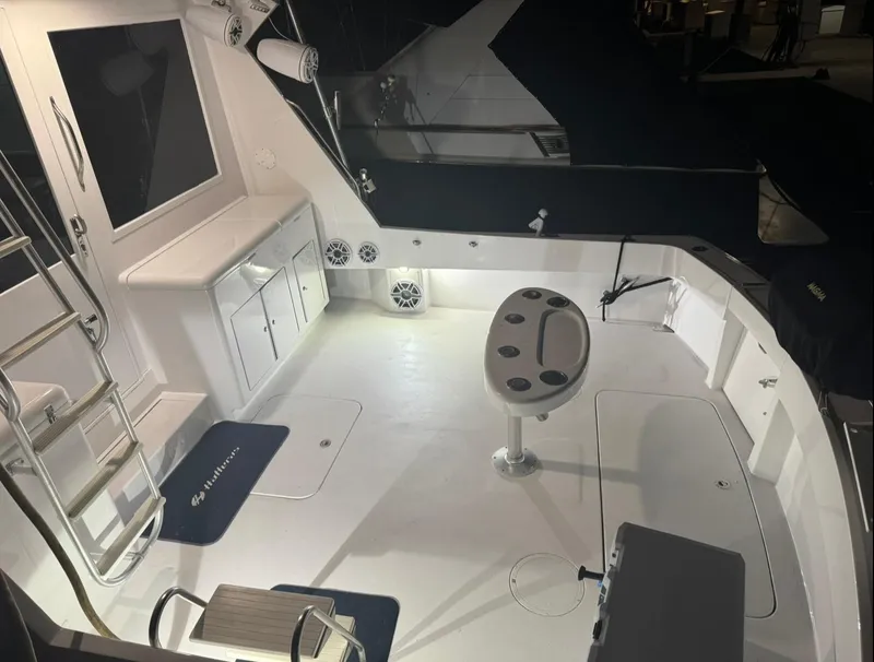 Slide: The Image of 1990 Hatteras 45 Convertible yacht deck with seating and storage compartments. - 32