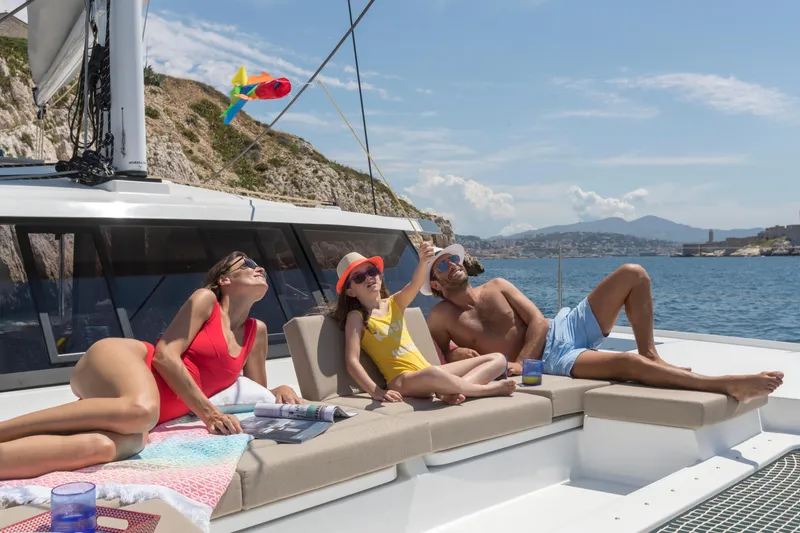 Slide: The Image of Family relaxing on 2024 Fountaine Pajot Astrea 42 catamaran, enjoying sunny day on the water. - 3