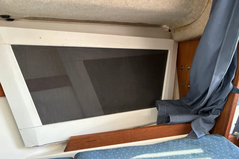 Slide: The Image of Interior of a 2002 Precision 23 sailboat with window and blue curtain. - 17