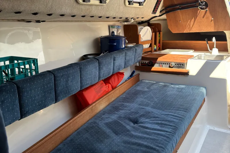 Slide: The Image of Interior of a 2002 Precision 23 sailboat with cozy seating and compact kitchen area. - 20