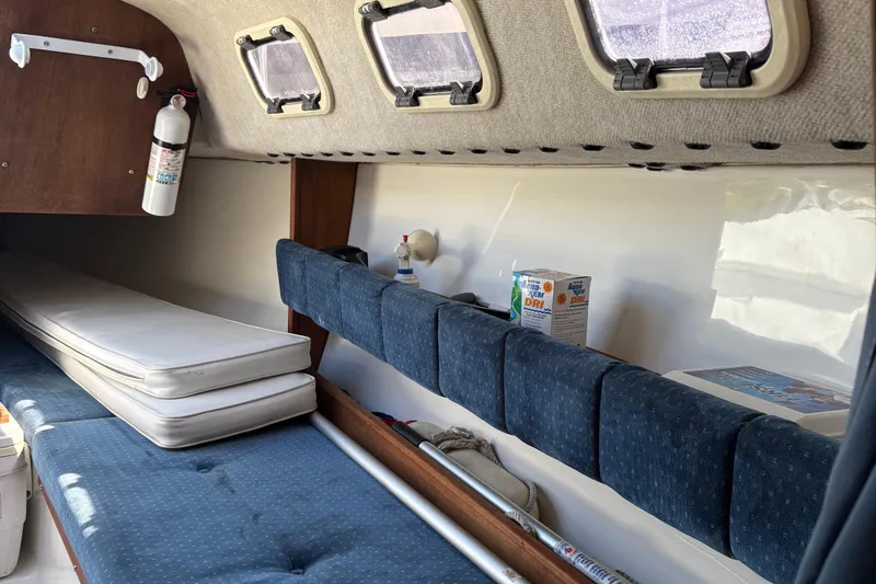 Slide: The Image of Interior of a 2002 Precision 23 sailboat with cushions and storage compartments. - 21