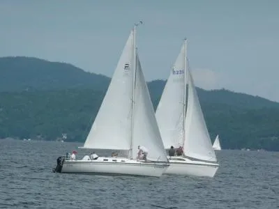 Slide: The Image of Two Precision 23 sailboats on a lake with mountainous background, 2002 model. - 3