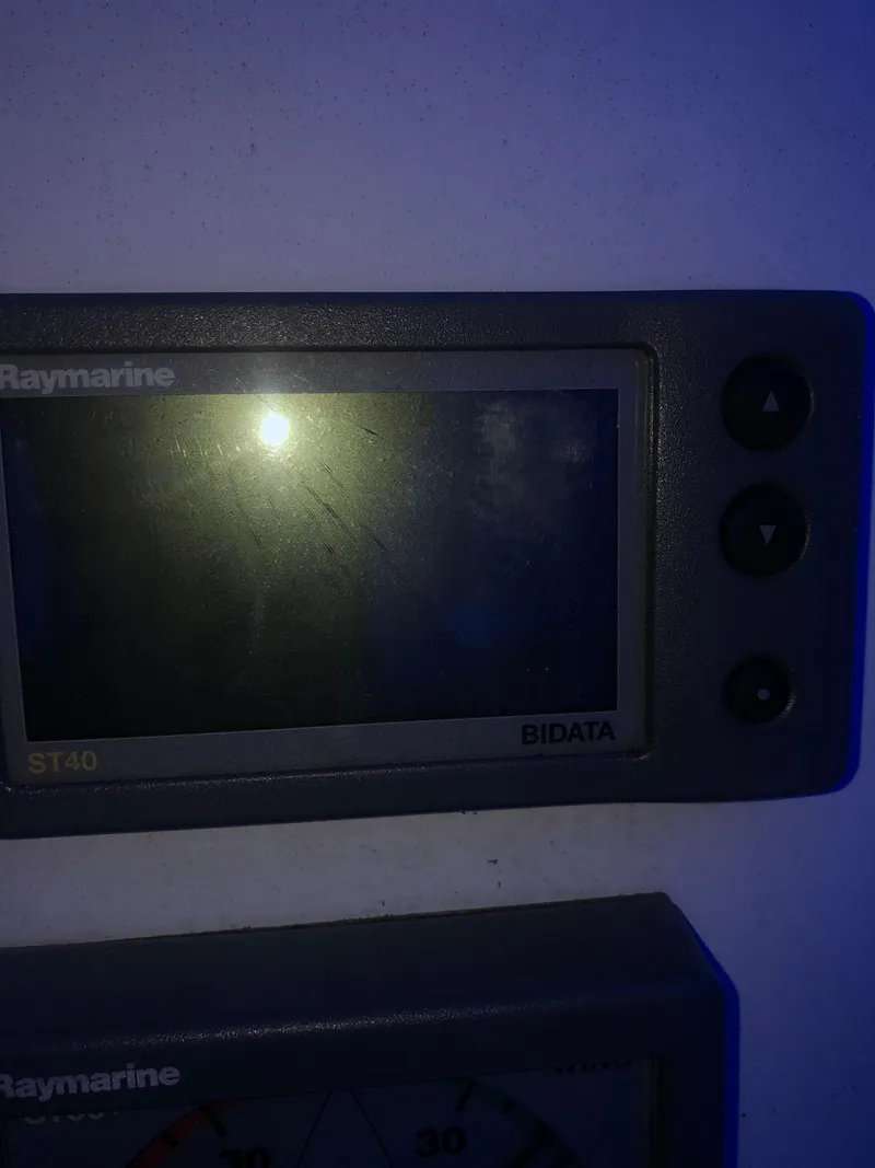 Slide: The Image of Raymarine ST40 Bidata display with buttons, illuminated in dim blue light. - 5