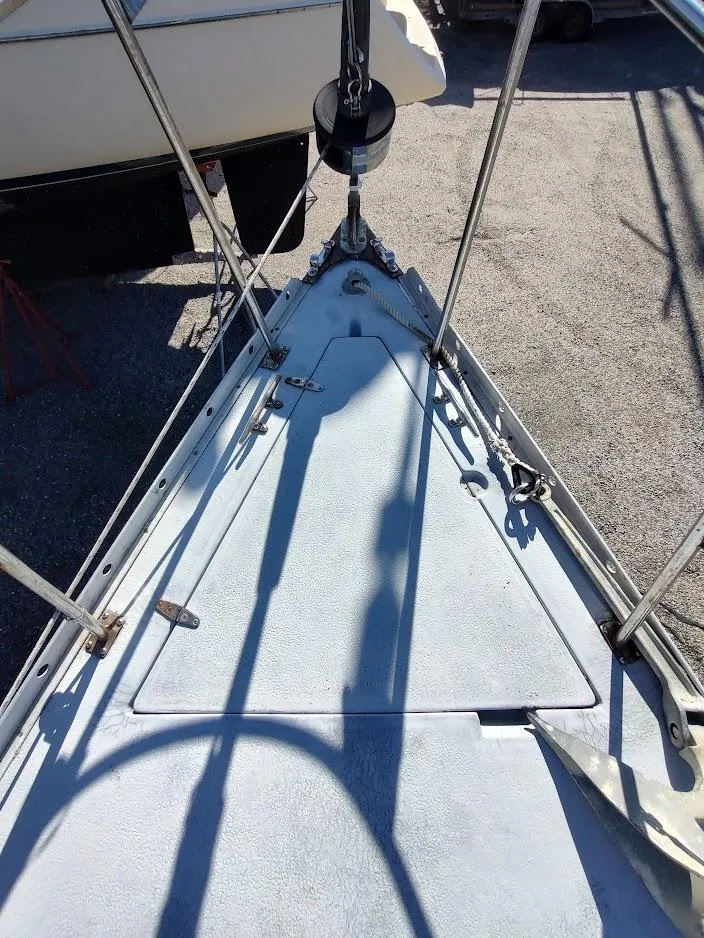 Slide: The Image of Bow of a 1979 Endeavour 32 sailboat with visible deck hardware and shadows. - 13