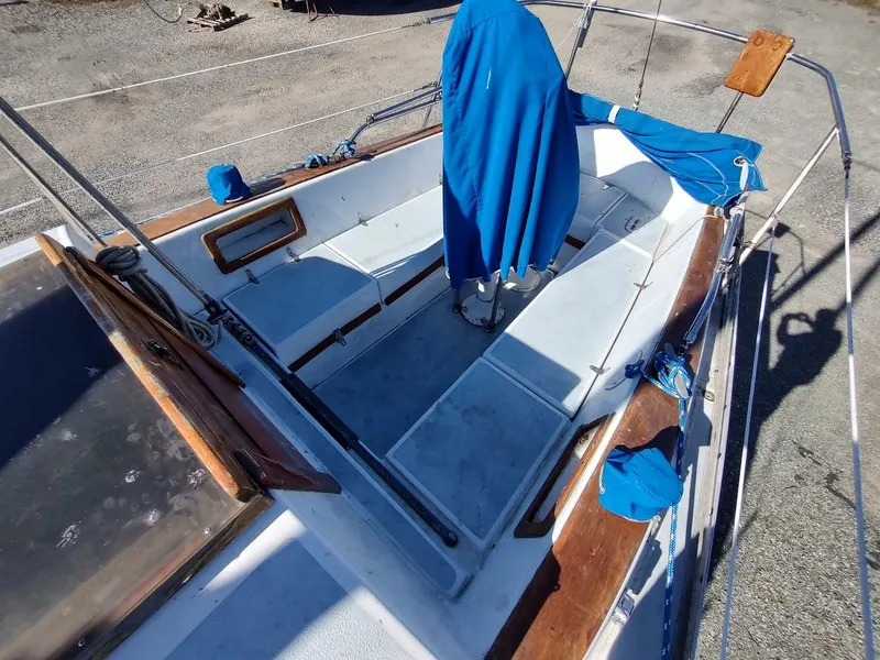 Slide: The Image of 1979 Endeavour 32 sailboat cockpit with blue covers and wooden accents. - 23