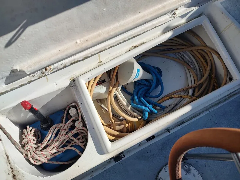 Slide: The Image of Storage compartment on a 1979 Endeavour 32 sailboat with ropes and cables. - 29