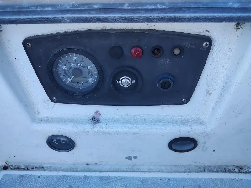 Slide: The Image of Instrument panel of a 1979 Endeavour 32 sailboat with RPM gauge and controls. - 32