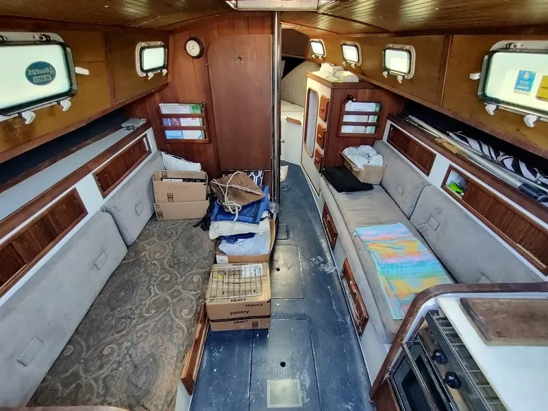 Slide: The Image of Interior of a 1979 Endeavour 32 sailboat with cozy seating and storage. - 34