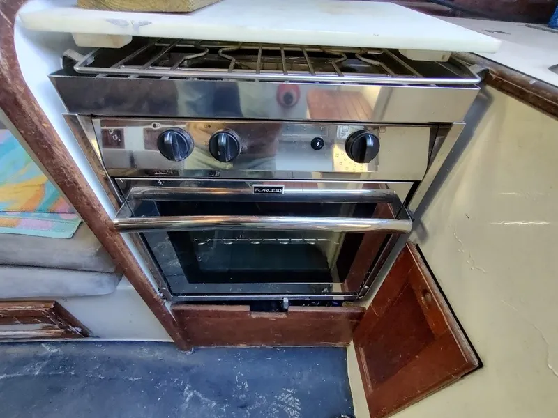 Slide: The Image of Stainless steel oven and stove in a 1979 Endeavour 32 sailboat kitchen. - 37