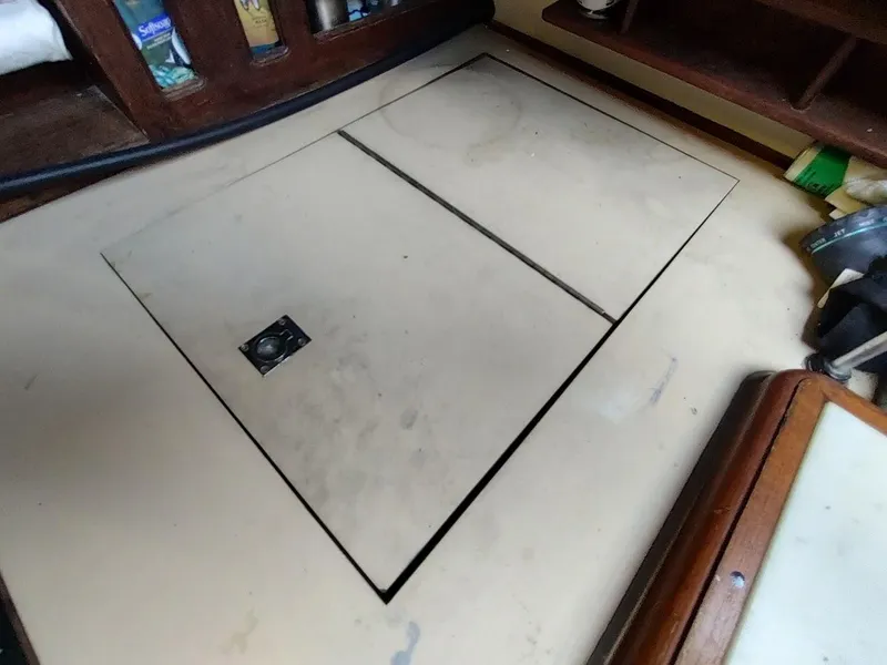 Slide: The Image of Floor hatch on a 1979 Endeavour 32 sailboat interior, with storage compartments. - 39