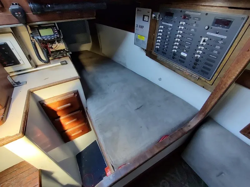 Slide: The Image of Interior of a 1979 Endeavour 32 sailboat showing navigation equipment and control panel. - 43