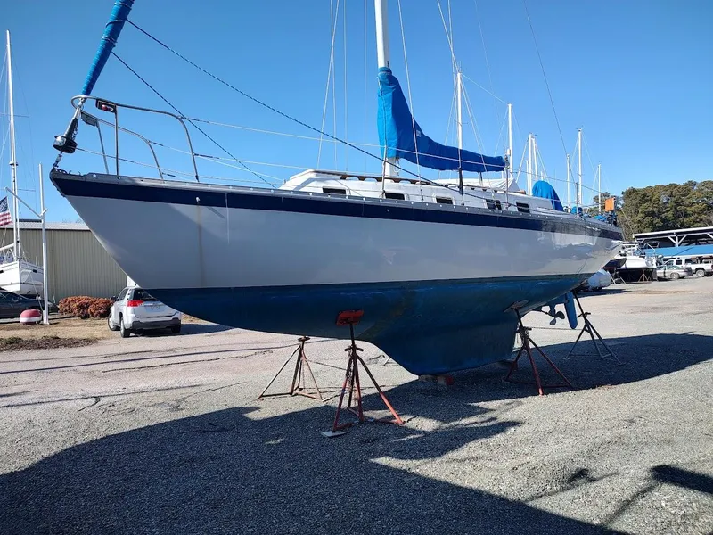 Slide: The Image of 1979 Endeavour 32 sailboat on stands in a boatyard under clear blue sky. - 5